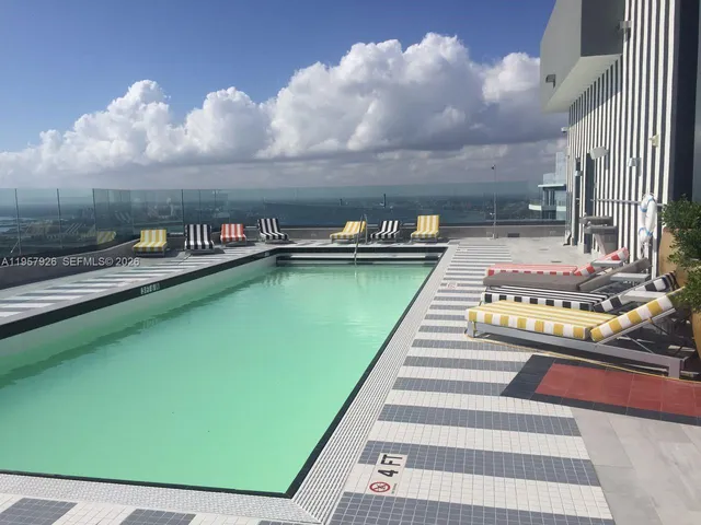 a view of a swimming pool with an outdoor seating