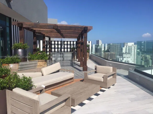 a view of a patio with couches table and chairs