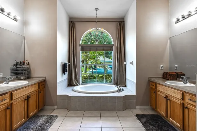 a bathroom with a tub sink toilet and mirror