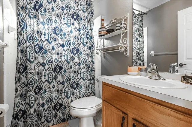 a bathroom with a sink toilet and a mirror