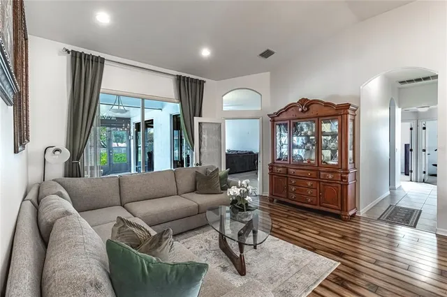 a living room with furniture and wooden floor