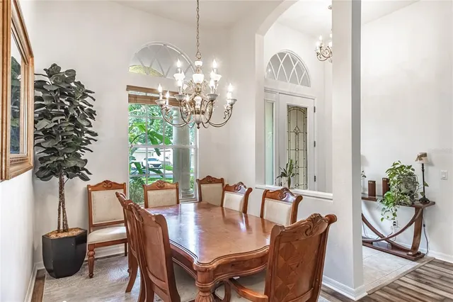 a view of a dining room with furniture and chandelier