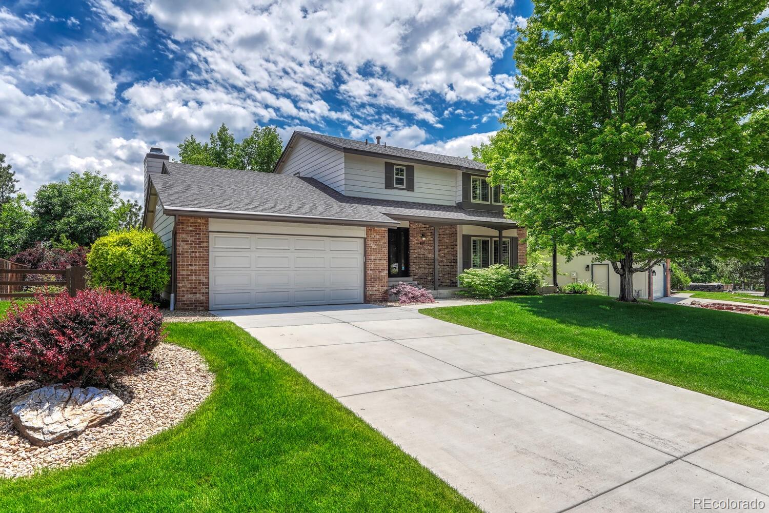 302 Northridge Road Highlands Ranch, CO 80126 - Photo 1 of 36 a front view of a house with a yard and garage