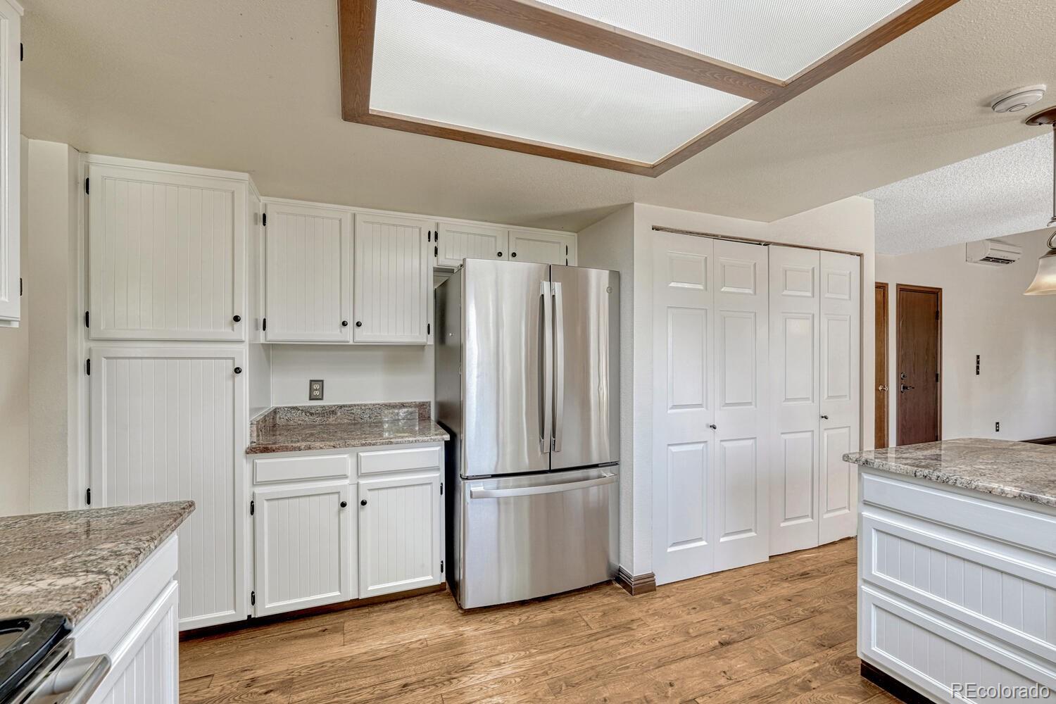 302 Northridge Road Highlands Ranch, CO 80126 - Photo 13 of 36 a kitchen with a refrigerator stove and white cabinets