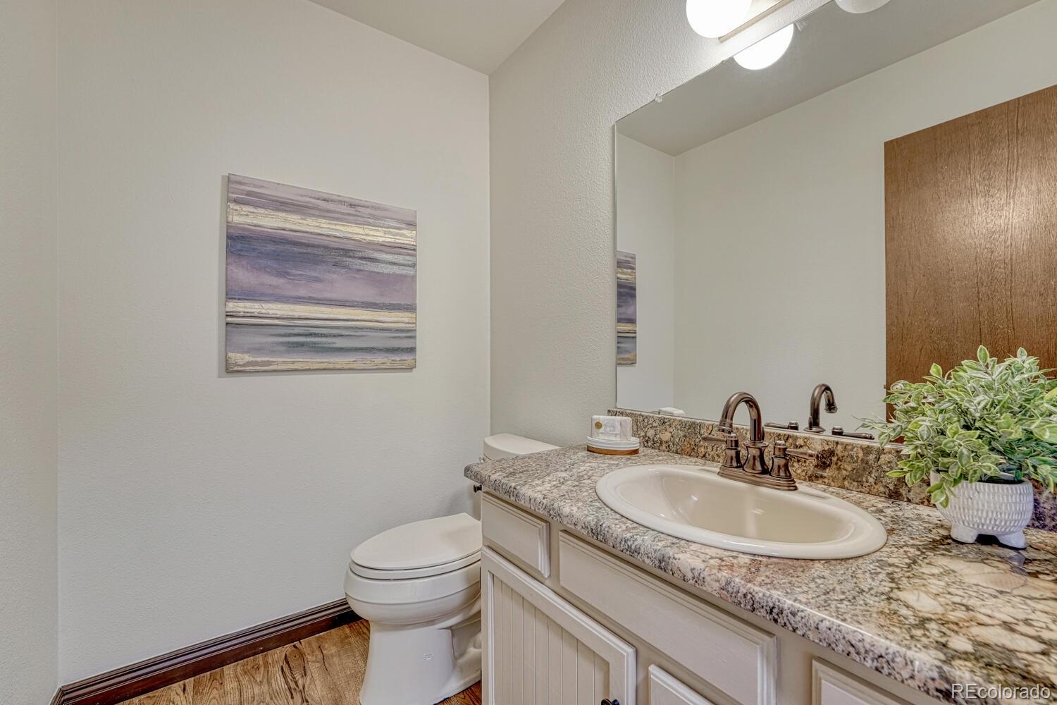 302 Northridge Road Highlands Ranch, CO 80126 - Photo 14 of 36 a bathroom with a granite countertop sink toilet and mirror