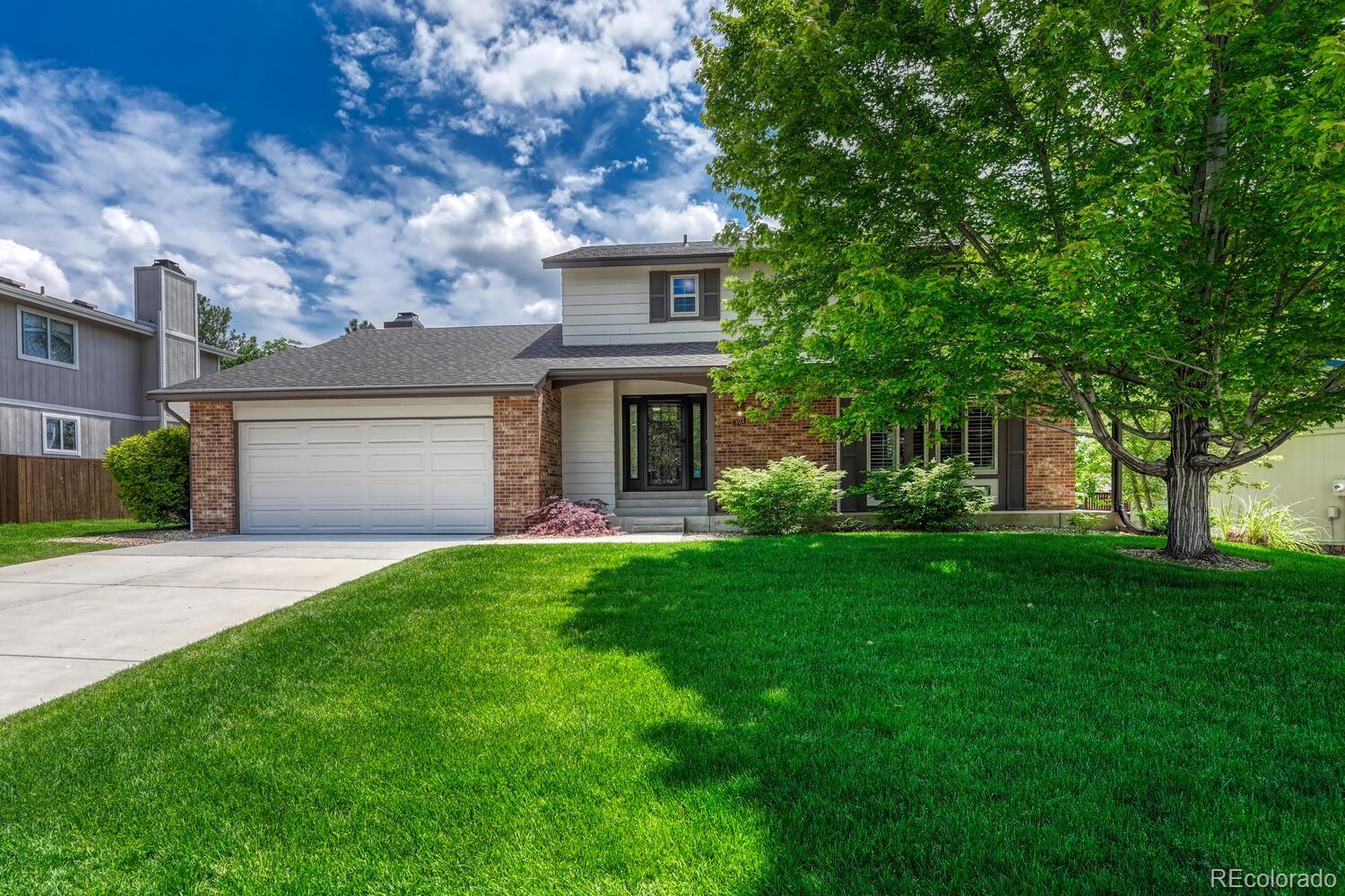 302 Northridge Road Highlands Ranch, CO 80126 - Photo 2 of 36 front view of a house with a yard