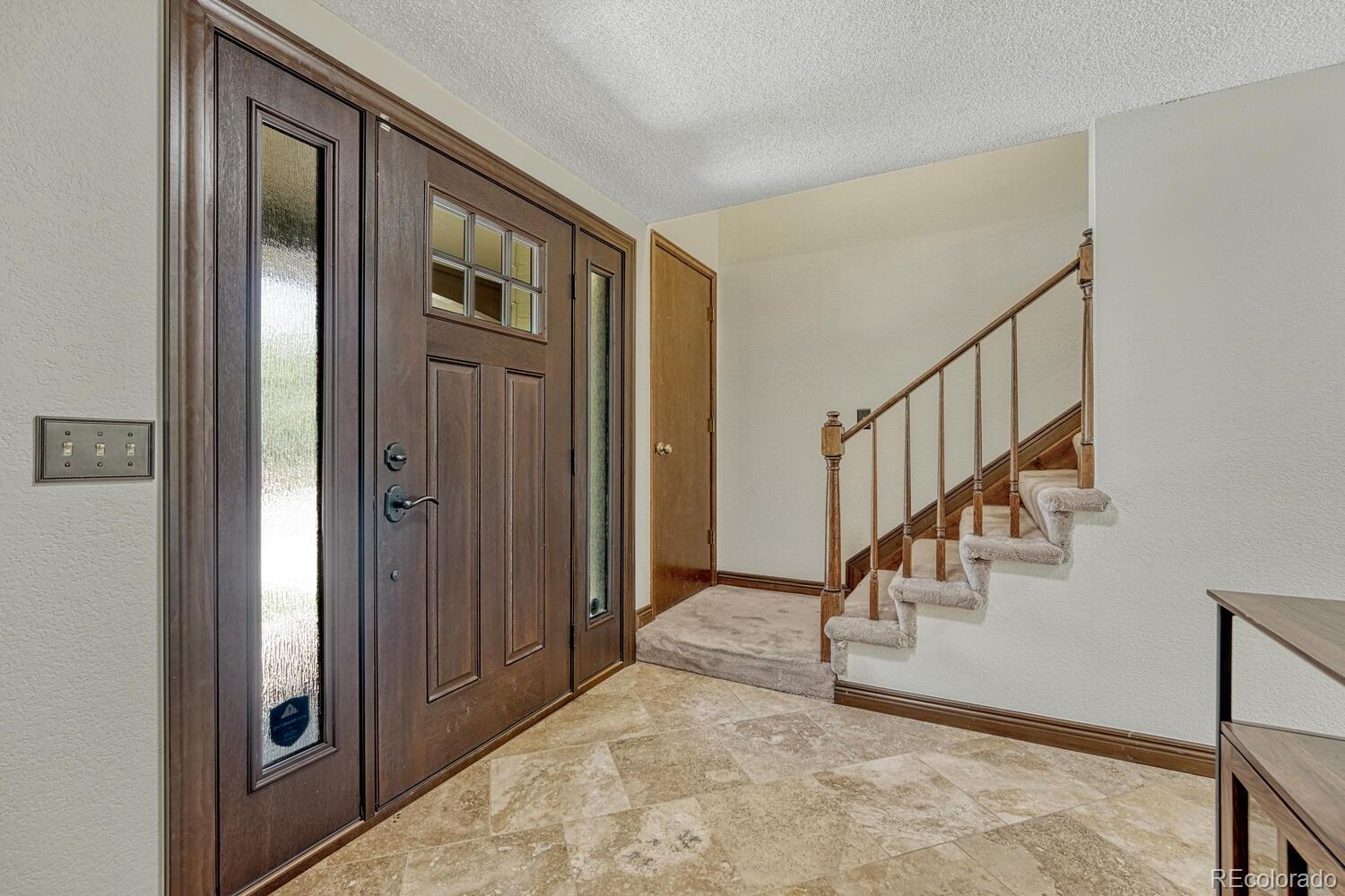 302 Northridge Road Highlands Ranch, CO 80126 - Photo 4 of 36 a view of an entryway with staircase
