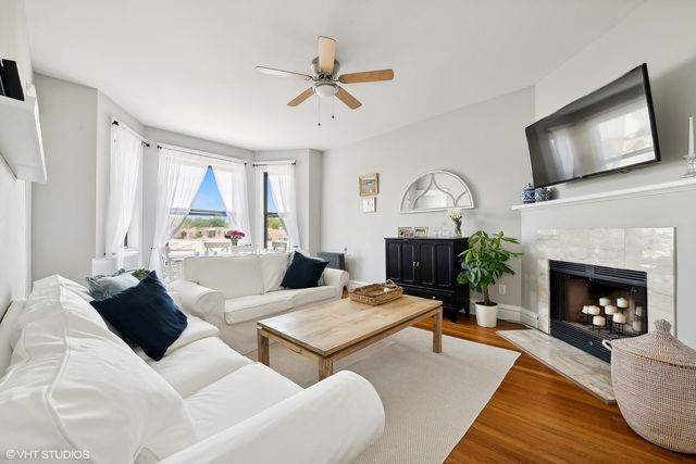 a living room with furniture a fireplace and a flat screen tv