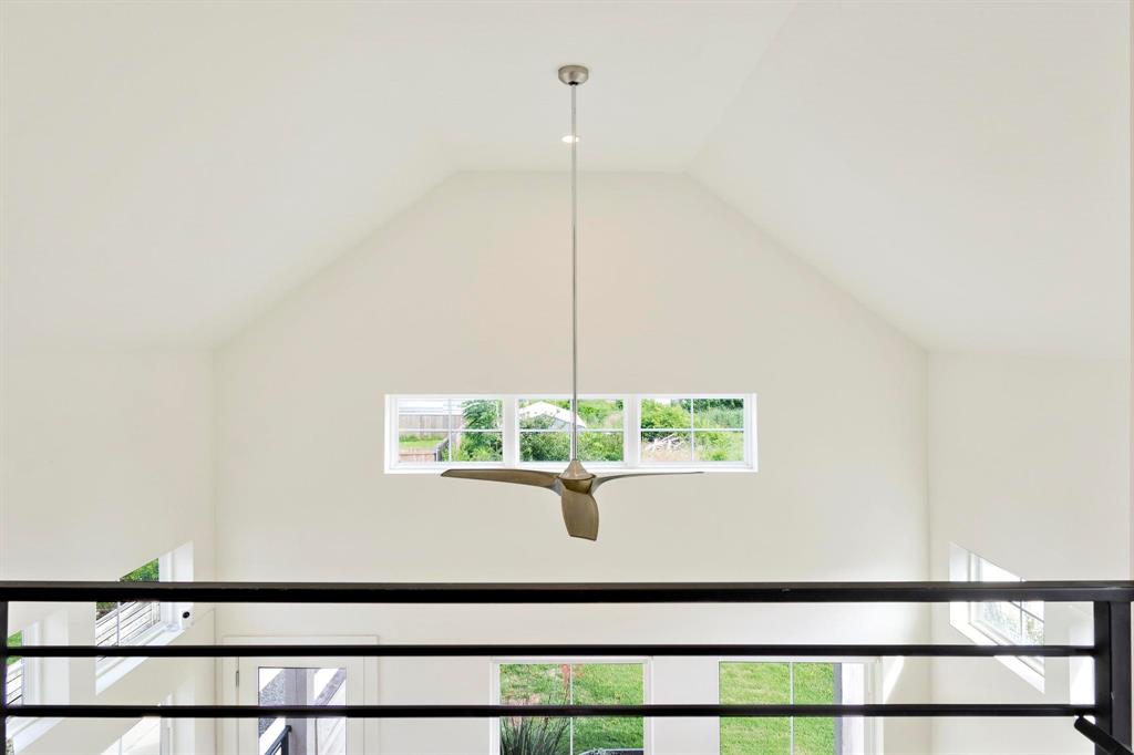 911 Stobaugh Street, Unit 2 Austin, TX 78757 - Photo 22 of 26 Vaulted ceiling featuring a modern ceiling fan, recessed lighting, and a horizontal window array