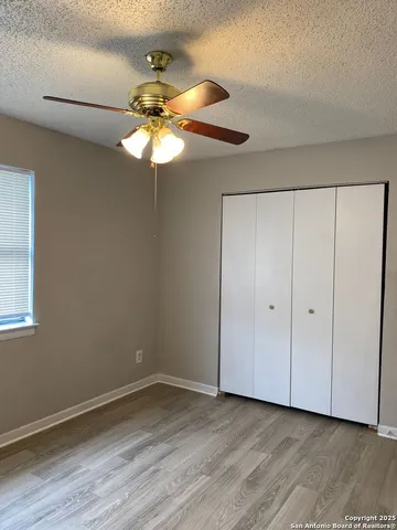 a view of a chandelier fan and hardwood floor