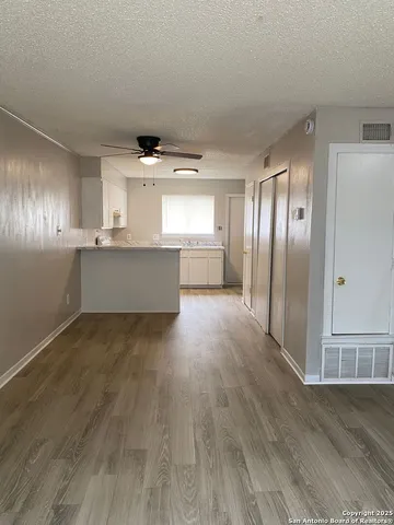 a kitchen with stainless steel appliances a refrigerator and wooden floor