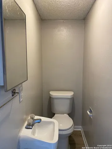 a white toilet sitting next to a bathroom sink