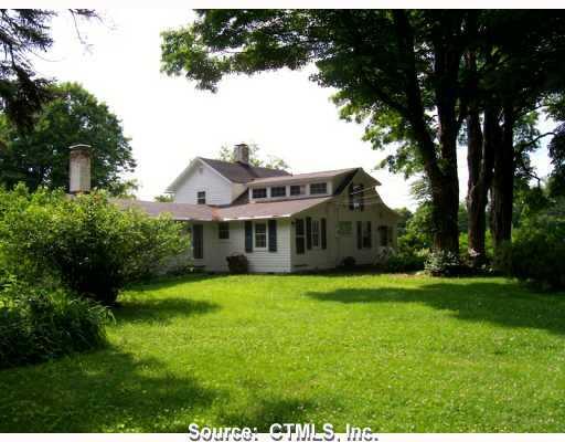 104 Norfolk Road Litchfield, CT 06759 - Photo 1 of 1 a front view of a house with a garden