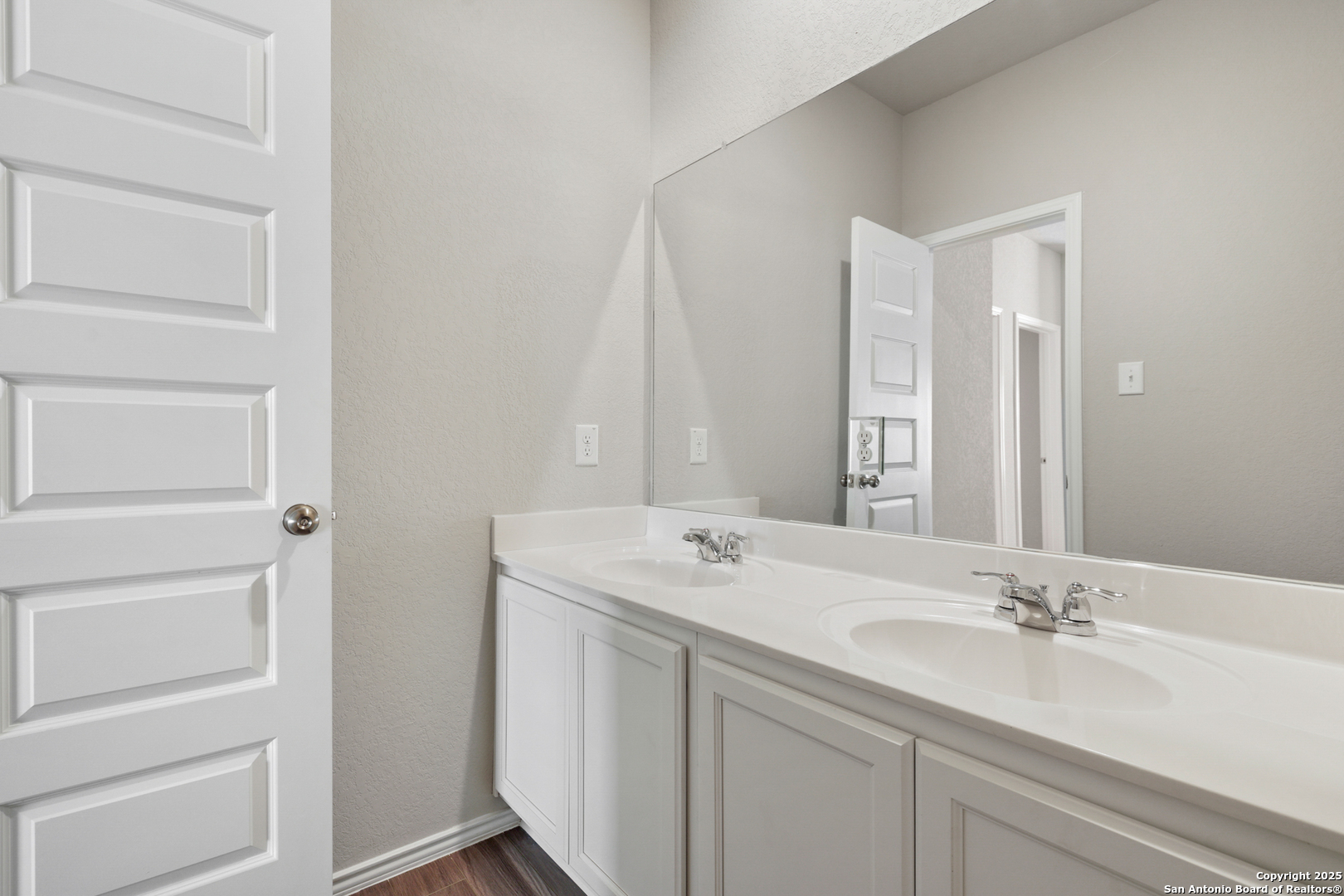 4946 Blue Ranch San Antonio, TX 78222 - Photo 18 of 32 a bathroom with a sink and a mirror