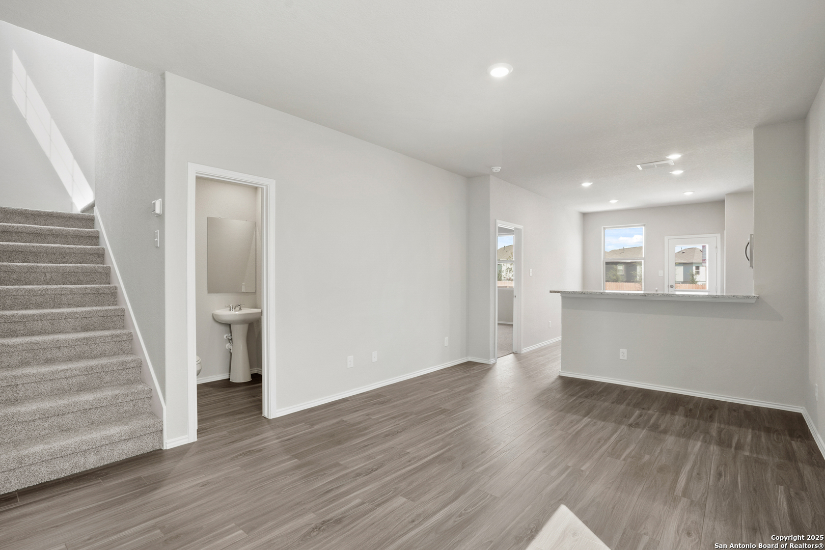 4946 Blue Ranch San Antonio, TX 78222 - Photo 4 of 32 a view of an empty room with wooden floor and stairs