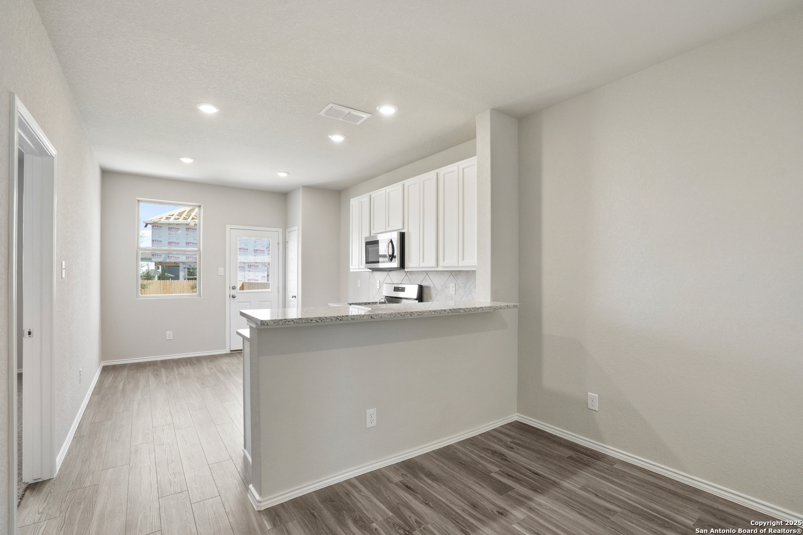 4946 Blue Ranch San Antonio, TX 78222 - Photo 7 of 32 a living room with stainless steel appliances wooden floor and view kitchen