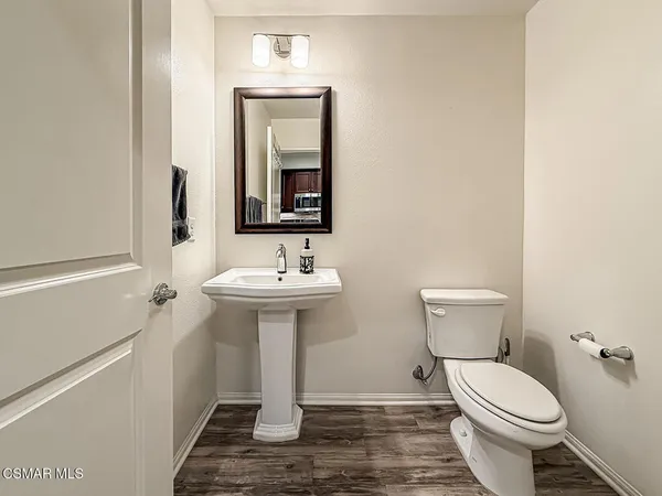 a bathroom with a sink toilet and mirror