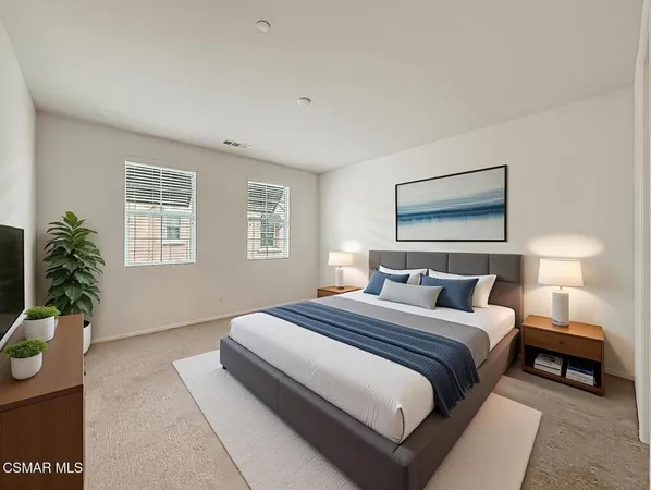 a bedroom with a bed and a potted plant