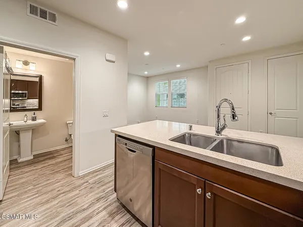 a kitchen with a sink and a refrigerator