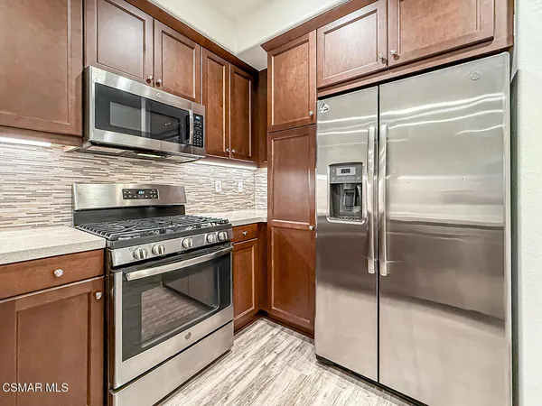 a kitchen with granite countertop stainless steel appliances and granite counter tops