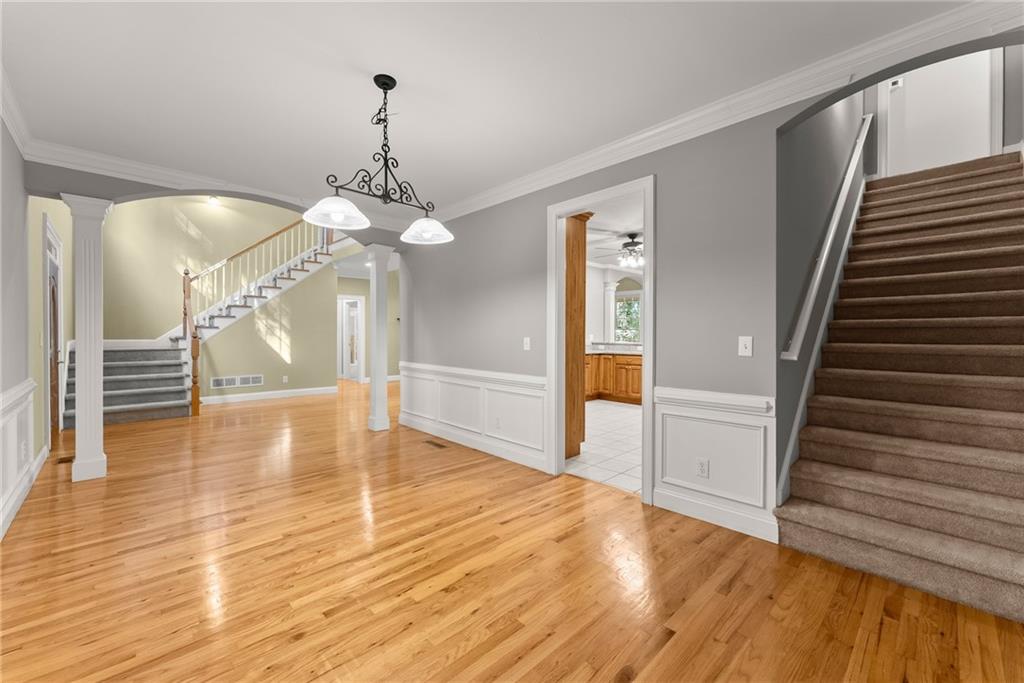1040 Auburn Road Dacula, GA 30019 - Photo 11 of 42 a view of a livingroom with wooden floor and staircase