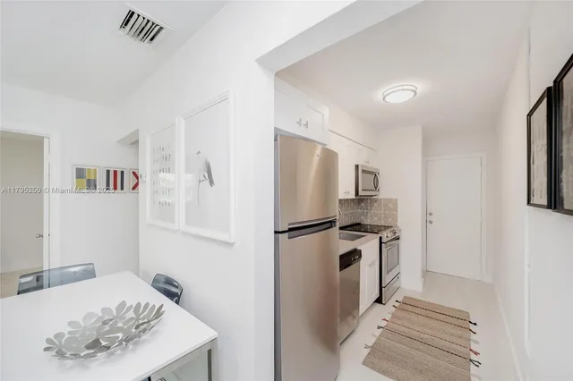a kitchen with a refrigerator sink and stove