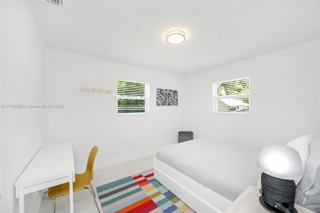 a bedroom with a bed and a chair