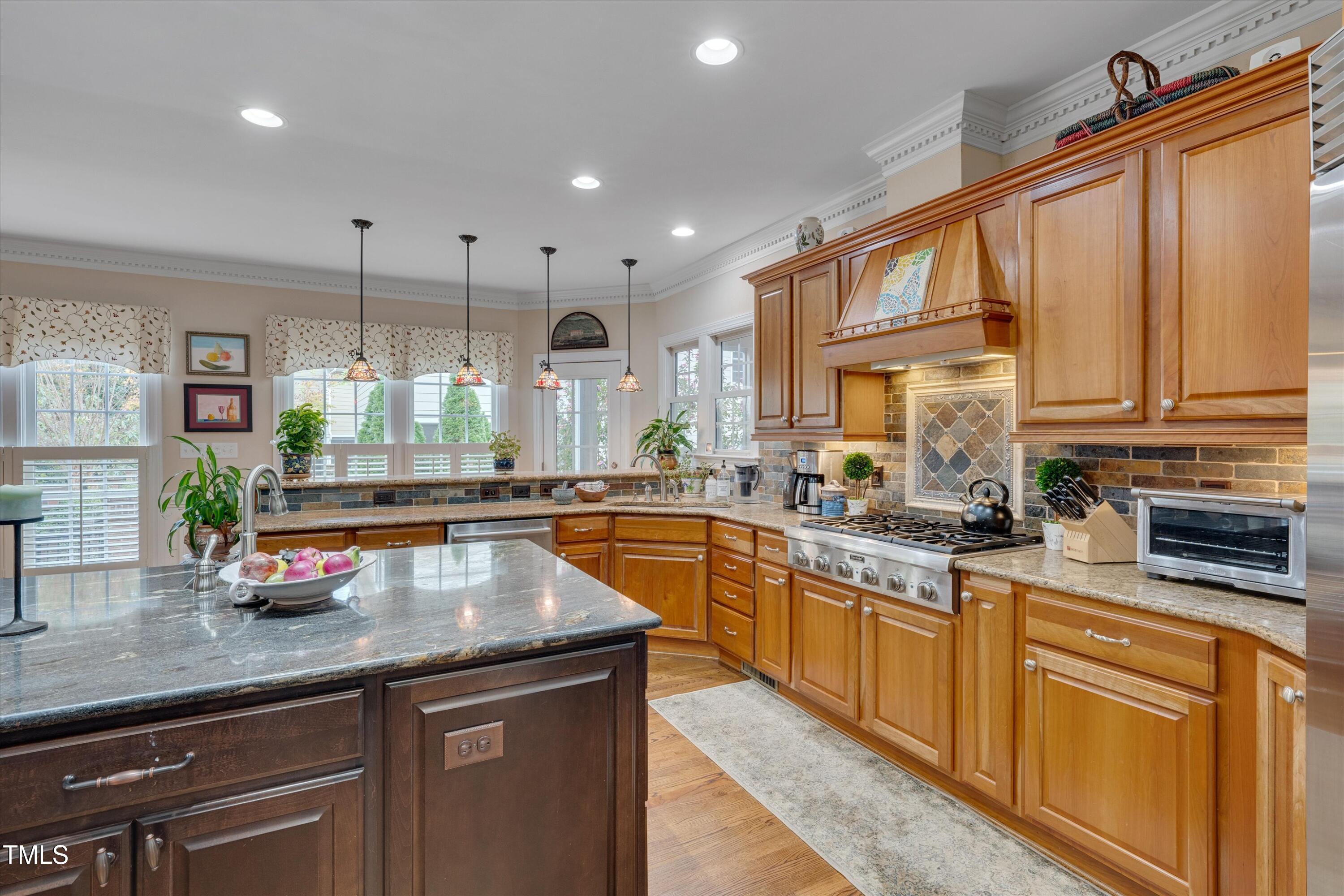 8308 Cazavini Court Raleigh, NC 27613 - Photo 11 of 46 a kitchen with stainless steel appliances granite countertop a sink a stove and cabinets