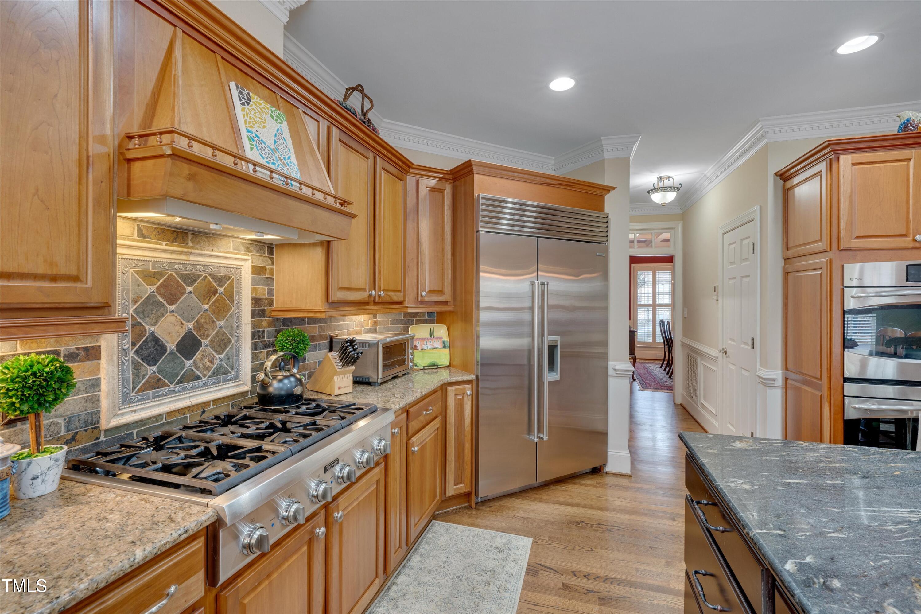 8308 Cazavini Court Raleigh, NC 27613 - Photo 12 of 46 a kitchen with stainless steel appliances granite countertop a stove a refrigerator and a oven