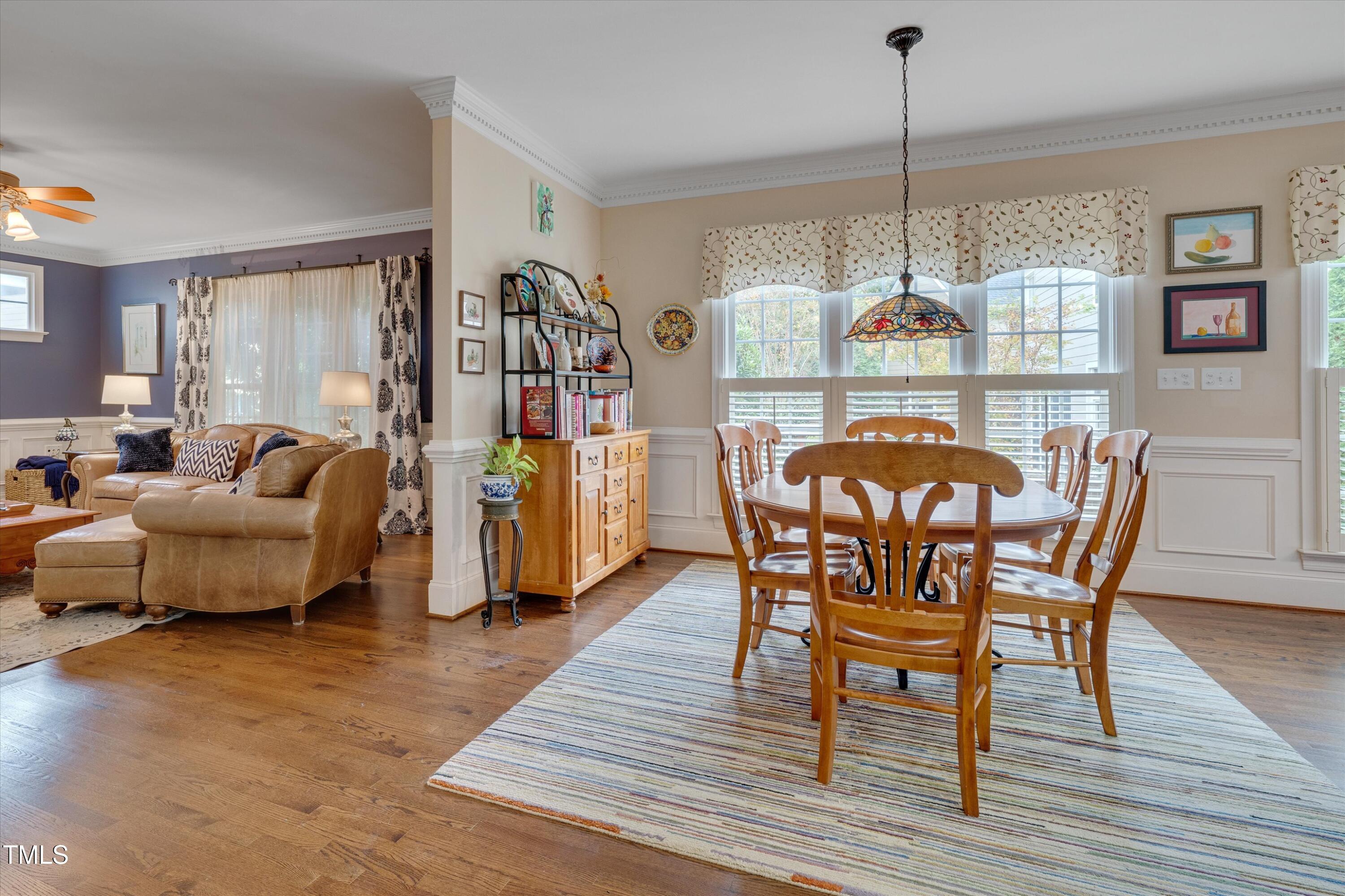8308 Cazavini Court Raleigh, NC 27613 - Photo 19 of 46 a dining room with furniture a chandelier and wooden floor