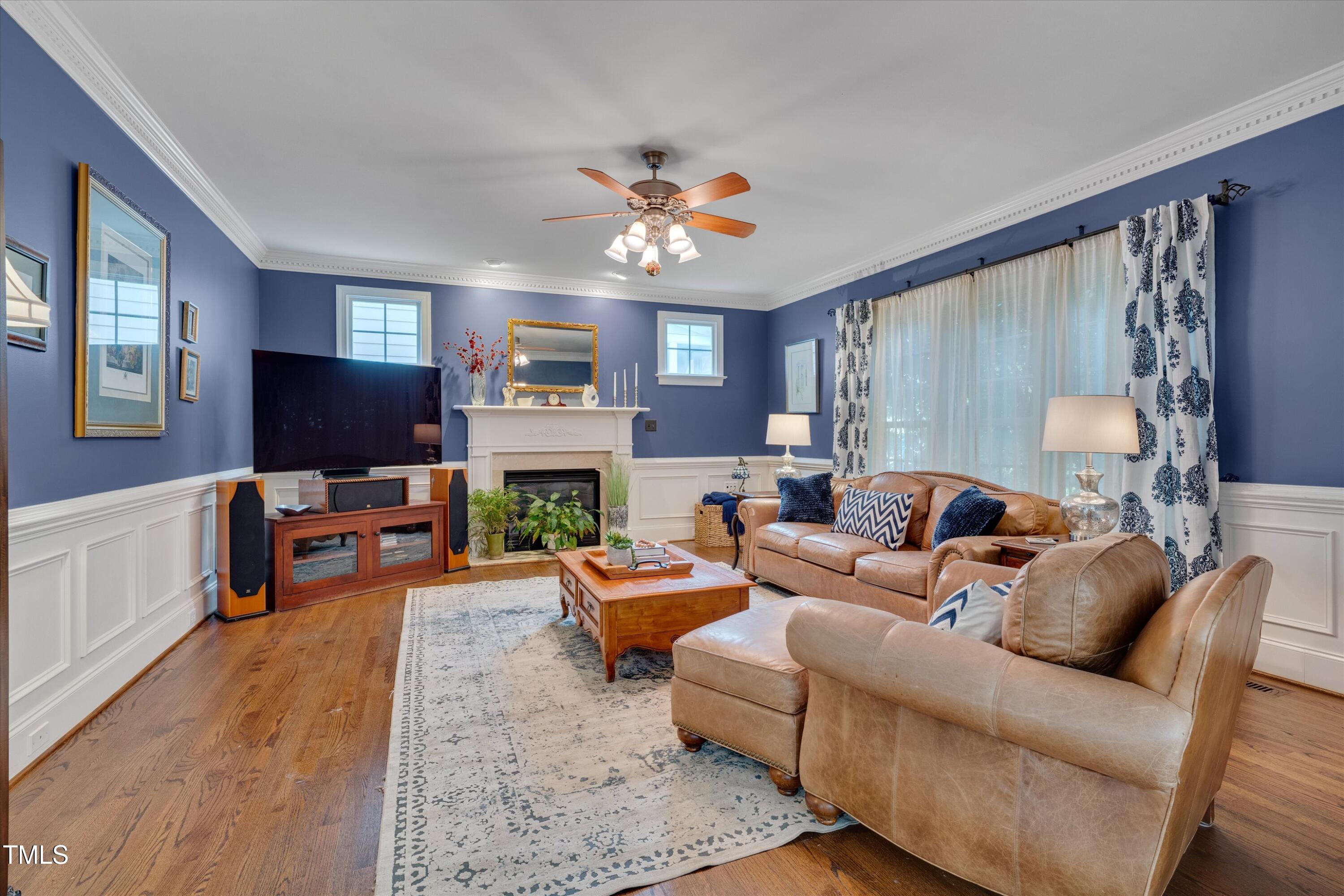8308 Cazavini Court Raleigh, NC 27613 - Photo 20 of 46 a living room with fireplace furniture and a flat screen tv