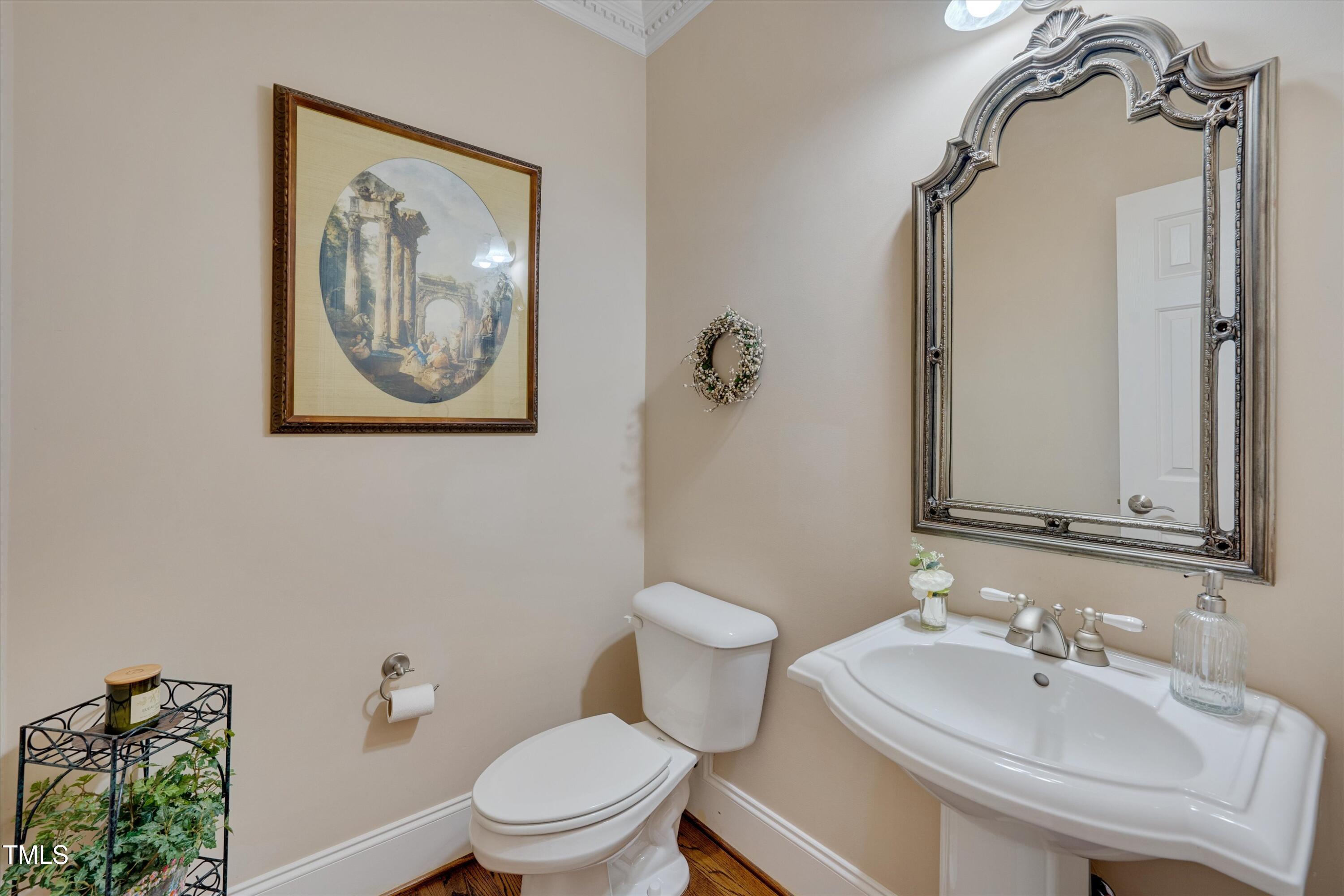 8308 Cazavini Court Raleigh, NC 27613 - Photo 23 of 46 a bathroom with a toilet sink and mirror