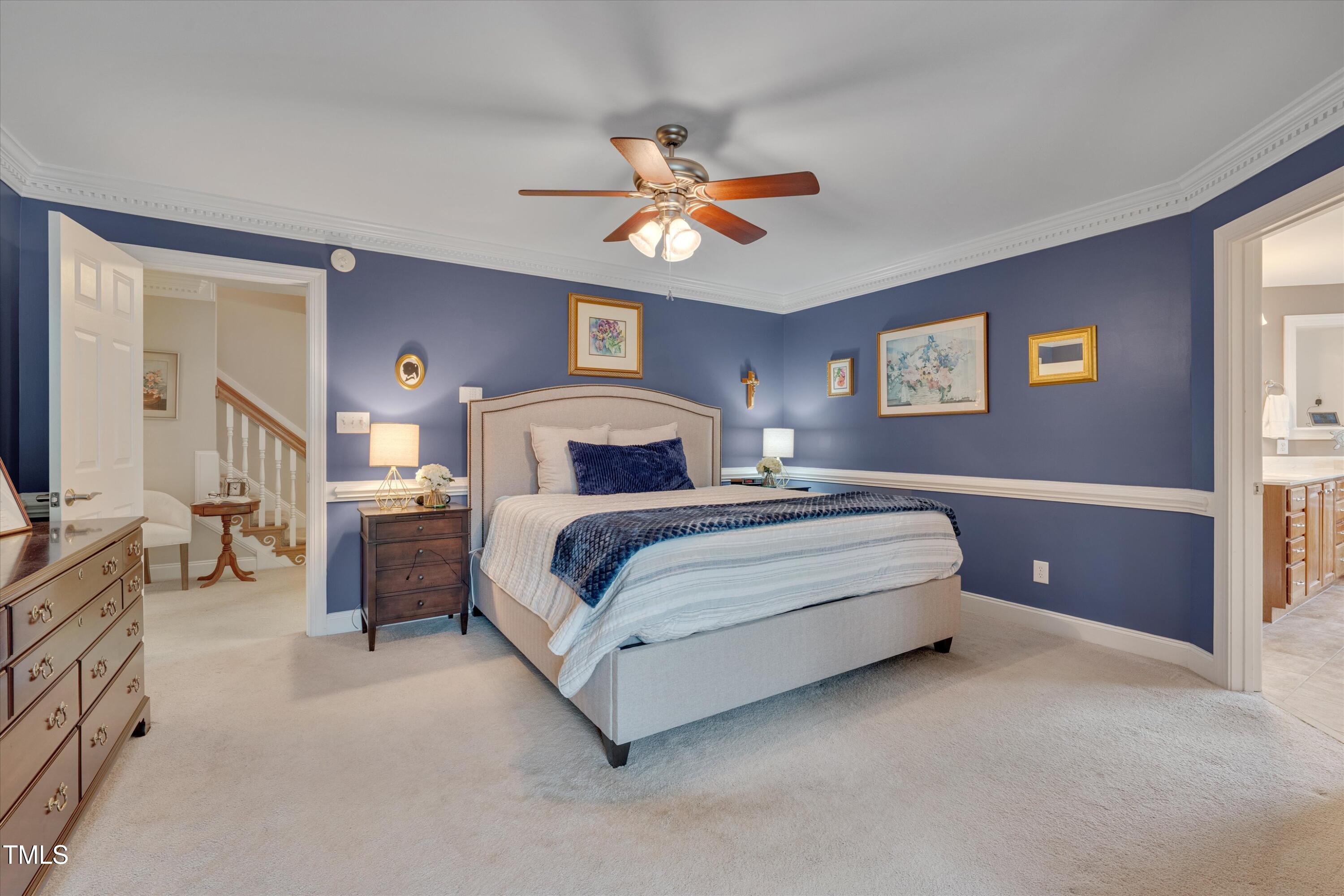 8308 Cazavini Court Raleigh, NC 27613 - Photo 29 of 46 a bedroom with a bed and a chandelier