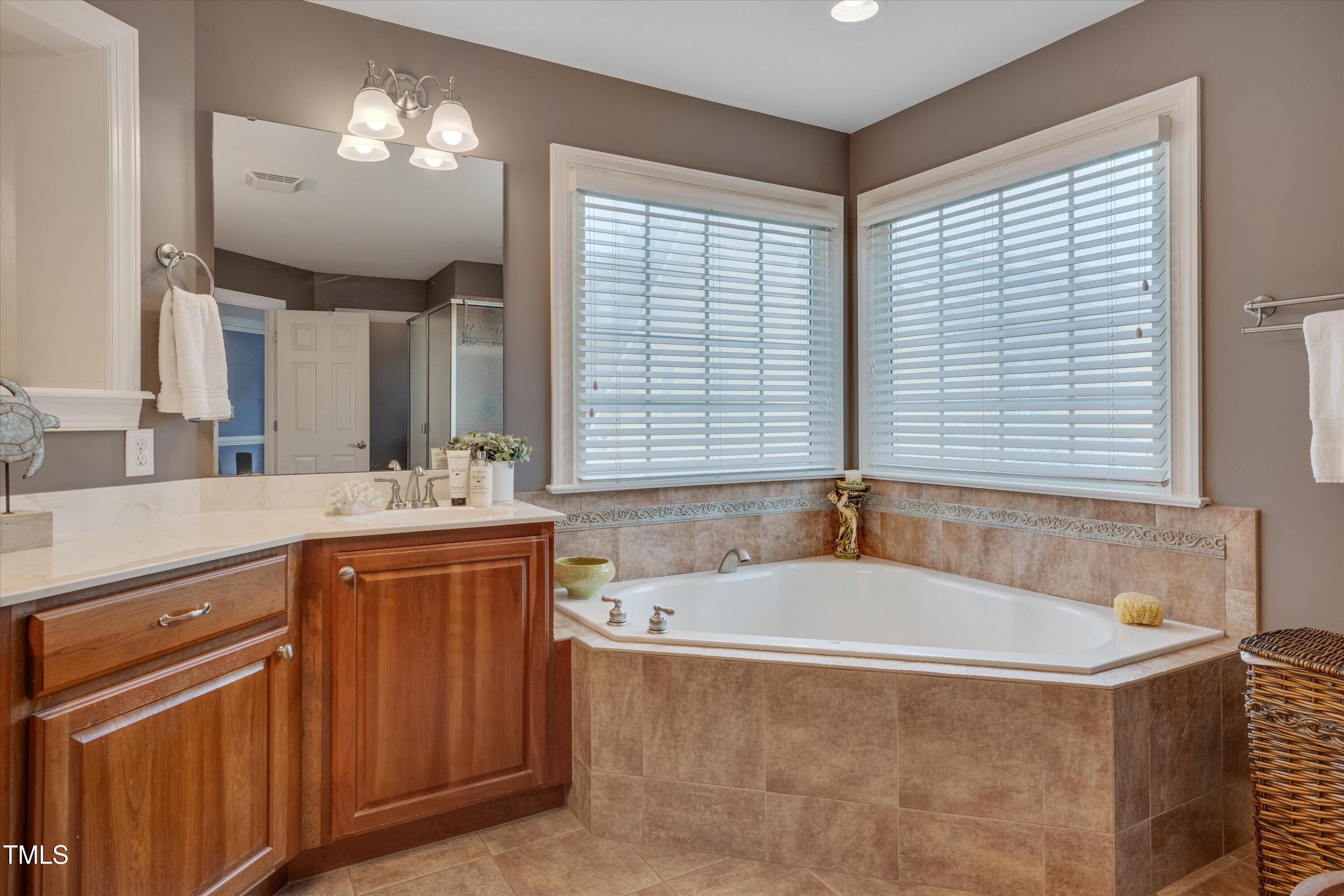 8308 Cazavini Court Raleigh, NC 27613 - Photo 32 of 46 a bath tub sitting in a bathroom next to a window
