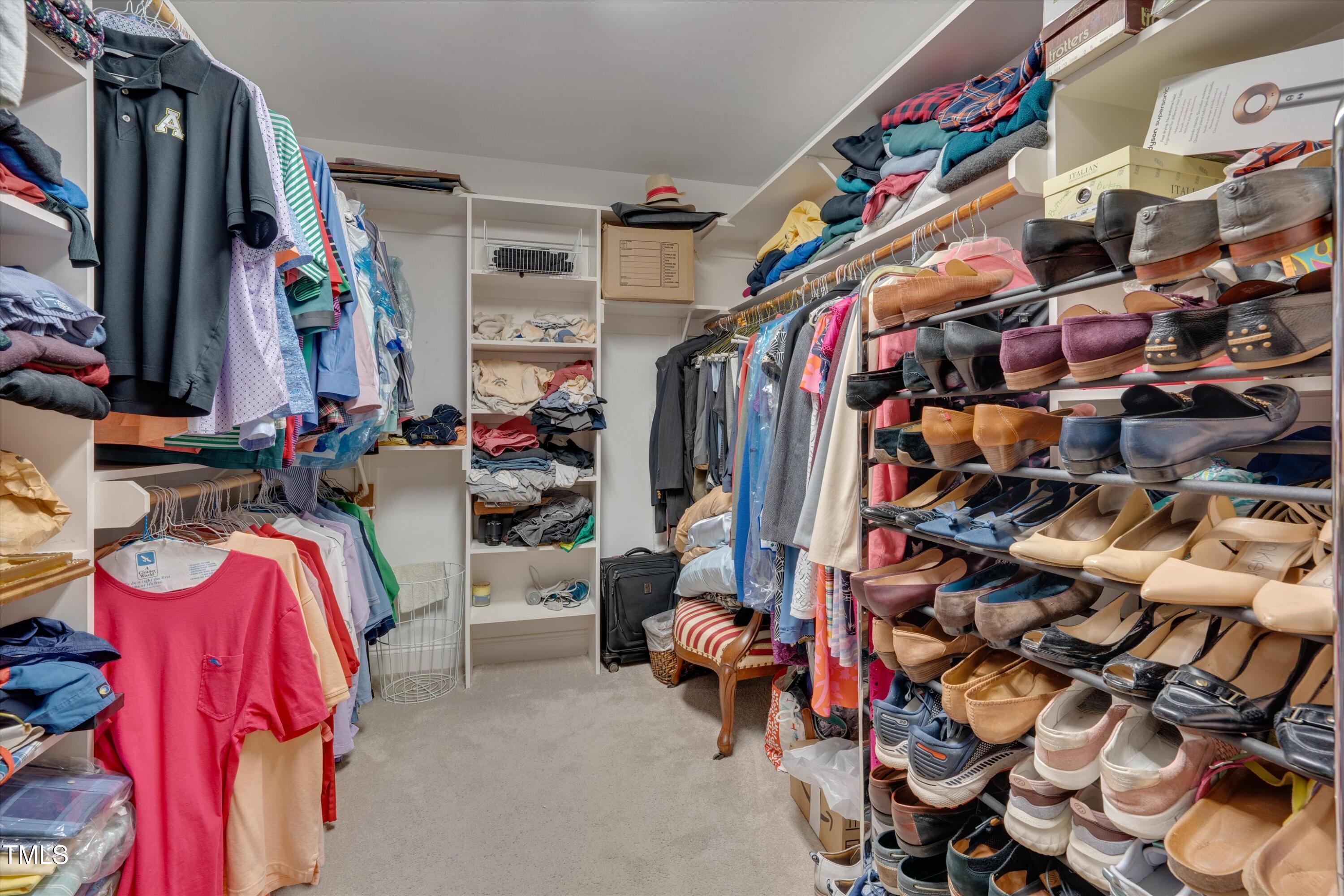 8308 Cazavini Court Raleigh, NC 27613 - Photo 34 of 46 a view of walk in closet with clothes and shoes