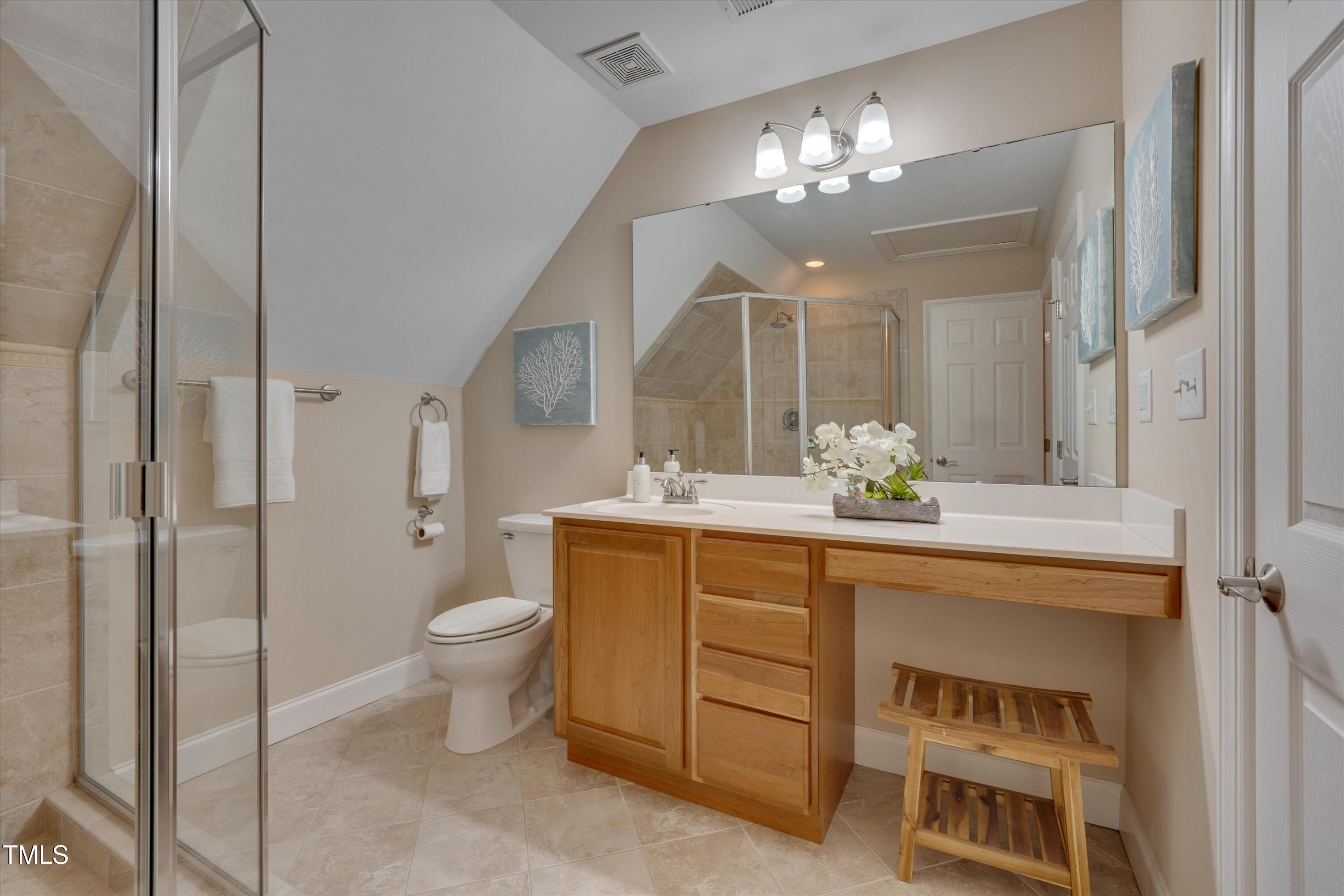 8308 Cazavini Court Raleigh, NC 27613 - Photo 40 of 46 a bathroom with a double vanity sink mirror and toilet