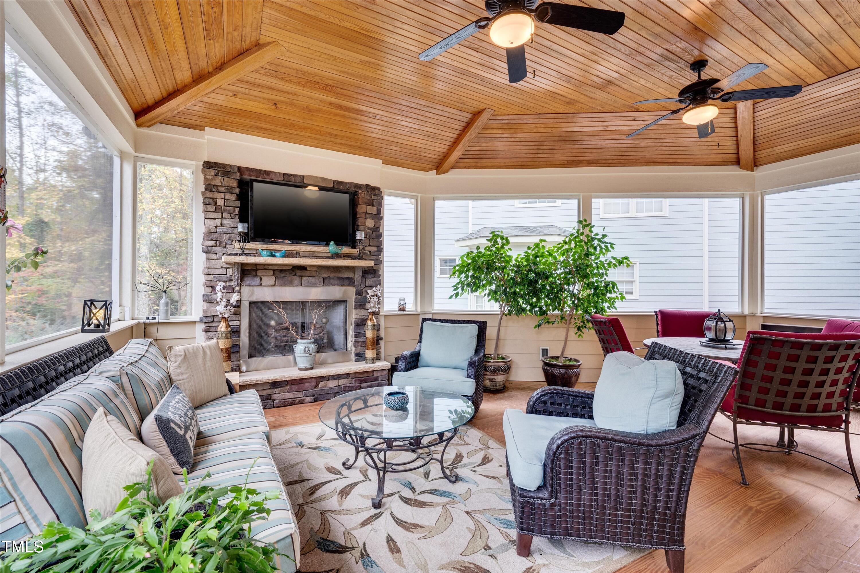 8308 Cazavini Court Raleigh, NC 27613 - Photo 42 of 46 a living room with furniture a flat screen tv and a fireplace