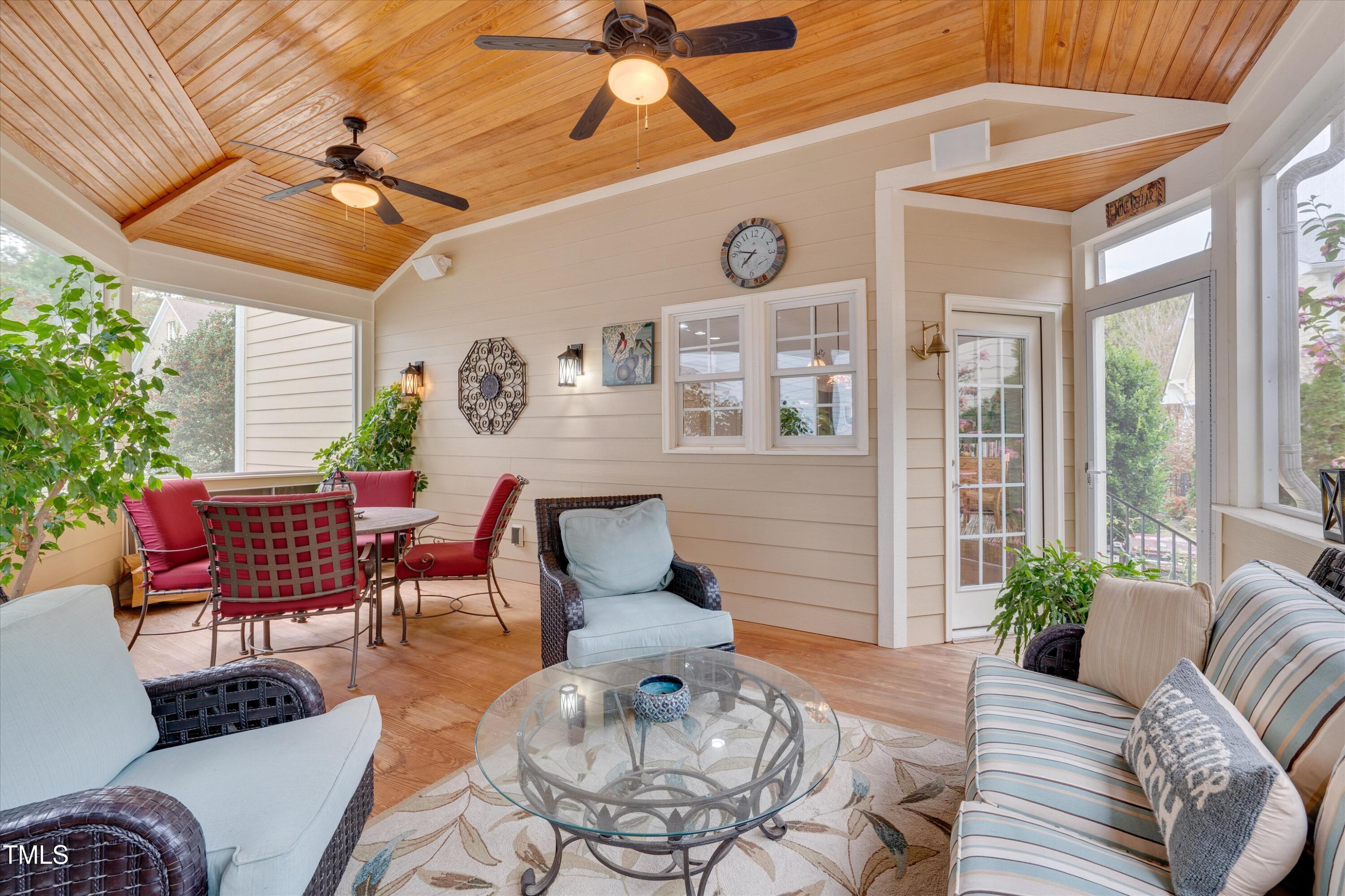 8308 Cazavini Court Raleigh, NC 27613 - Photo 43 of 46 a outdoor space with patio couches a table and chairs with wooden floor