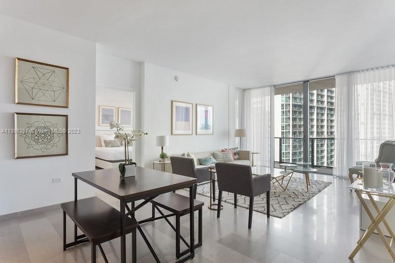 68 Southeast 6th Street, Unit 1209 Miami, FL 33131 - Photo 1 of 15 a view of a dining room with furniture and wooden floor