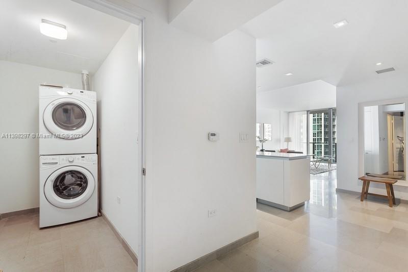68 Southeast 6th Street, Unit 1209 Miami, FL 33131 - Photo 11 of 15 a view of kitchen and washer and dryer