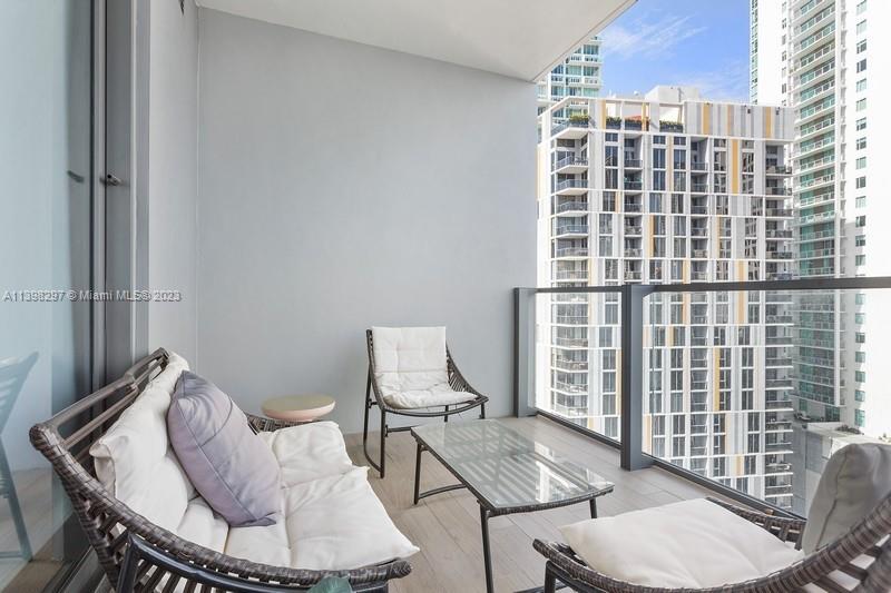 68 Southeast 6th Street, Unit 1209 Miami, FL 33131 - Photo 14 of 15 a living room with furniture and a window
