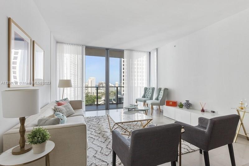 68 Southeast 6th Street, Unit 1209 Miami, FL 33131 - Photo 2 of 15 a living room with furniture and a large window
