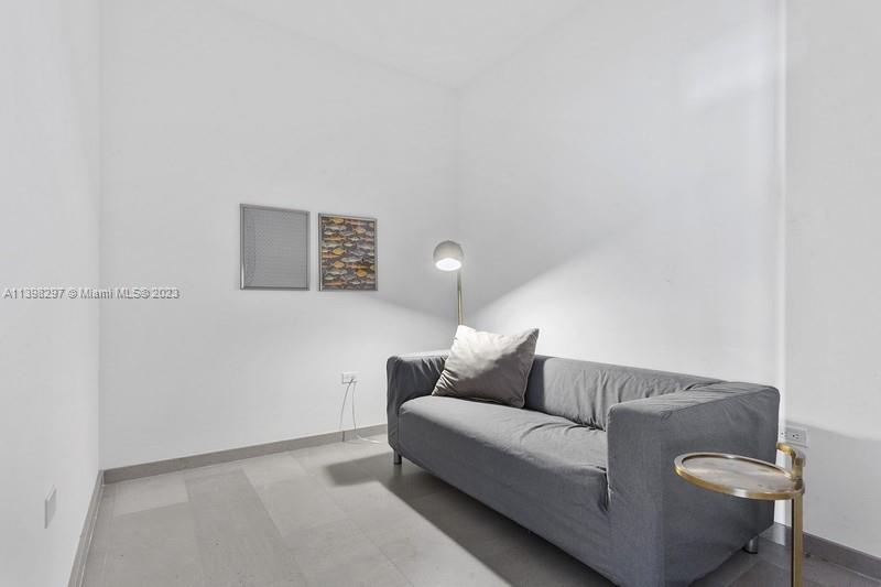 68 Southeast 6th Street, Unit 1209 Miami, FL 33131 - Photo 6 of 15 a living room with furniture and a lamp