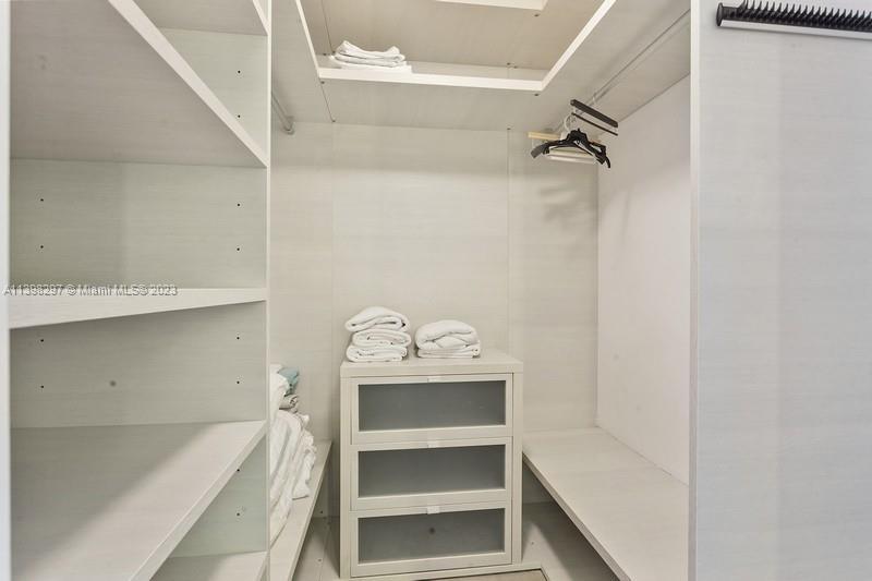 68 Southeast 6th Street, Unit 1209 Miami, FL 33131 - Photo 10 of 15 a view of walk in closet with empty racks