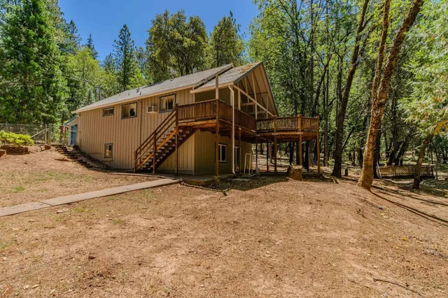 a kitchen with stainless steel appliances wooden cabinets and a stove top oven
