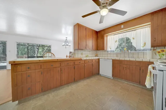 a view of a kitchen with wooden floor and electronic appliances