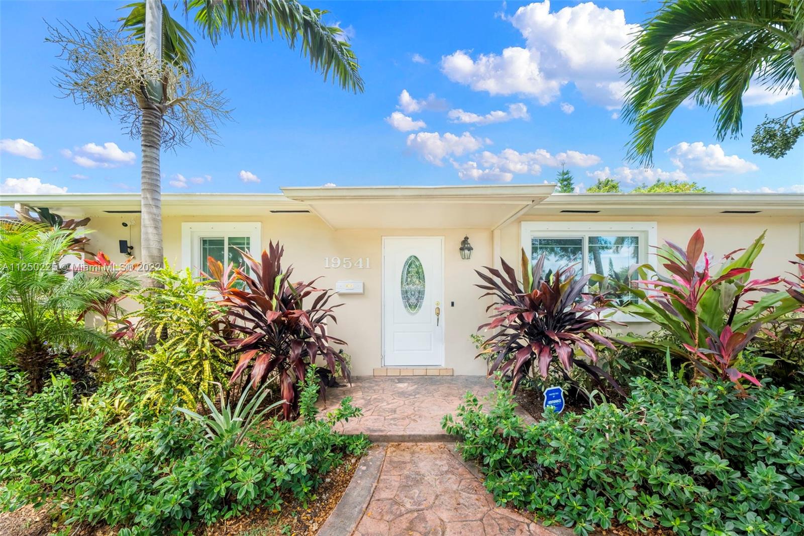 19541 Franjo Road Cutler Bay, FL 33157 - Photo 1 of 28 a couple of flower plants in front of building