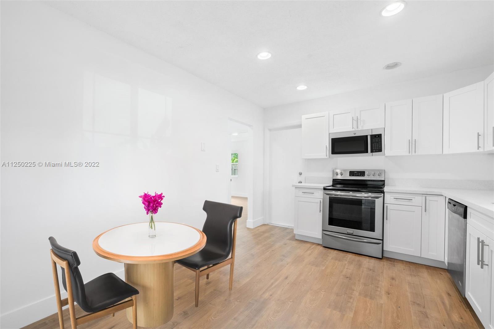 19541 Franjo Road Cutler Bay, FL 33157 - Photo 20 of 28 a kitchen with stainless steel appliances a dining table chairs microwave and sink