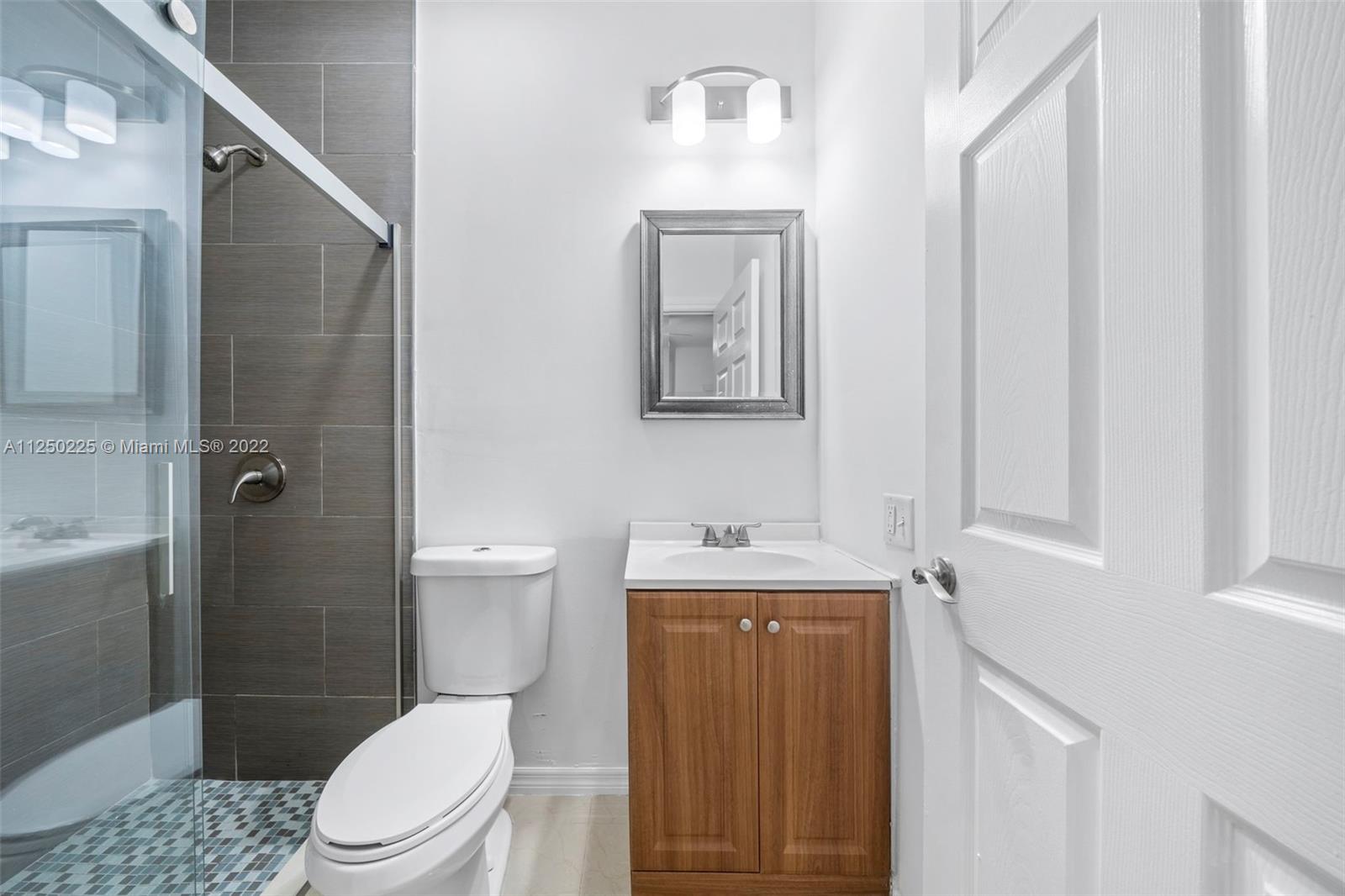 19541 Franjo Road Cutler Bay, FL 33157 - Photo 23 of 28 a bathroom with a toilet a sink and shower