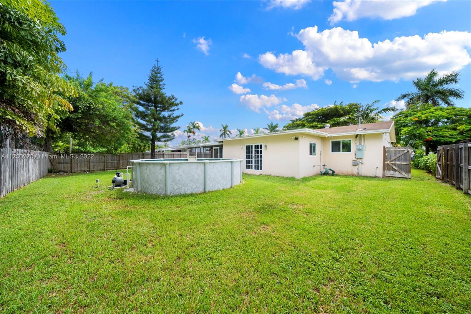 19541 Franjo Road Cutler Bay, FL 33157 - Photo 25 of 28 a view of a backyard with a garden and deck
